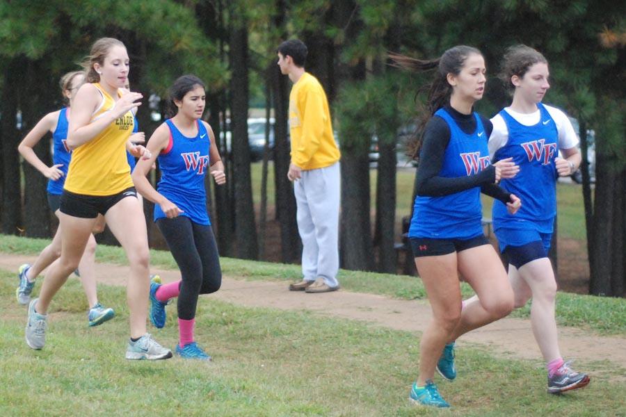 Junior Leah Weber (front right) and seniors Brooke MacKenzie (front left) and Elizabeth Prosser compete in the Oct. 9 race against Enloe. All three finished ahead of the 2nd through 6th Enloe runners. 