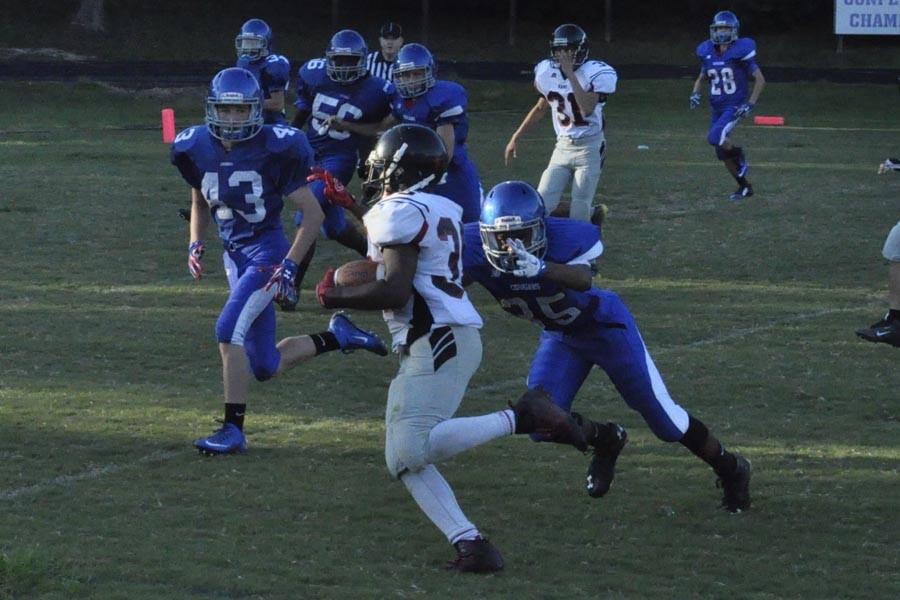 Cameron Blount (#35) closes on a Rolesville running back while Michael Wall (#43) looks to assist. 