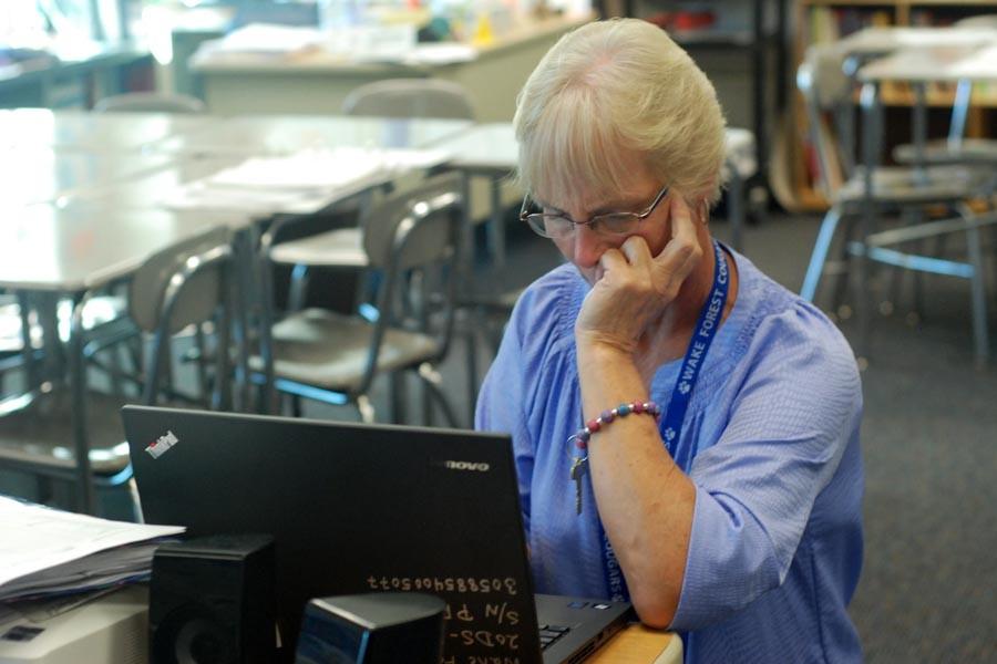 Social studies teacher Laura Hartman works with her new laptop purchased by WCPSS as a part of a multi-year roll out of new technology. Hartmans an all other teacher laptops will be re-purposed for student use. 