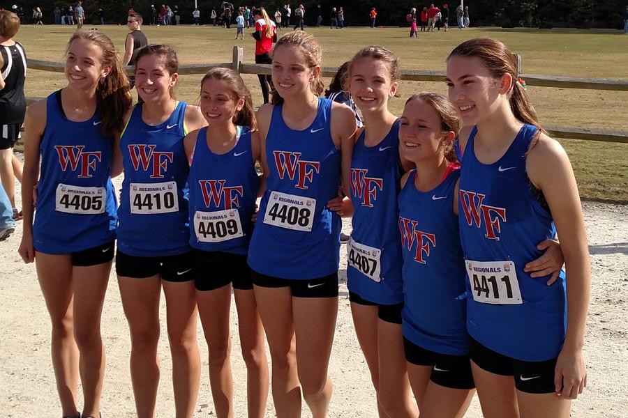 The girls cross country team pose at the NCHSAA regional meet Oct. 31. The girls took the last qualifying slot from Broughton to be able to attend the state meet Nov. 7. 