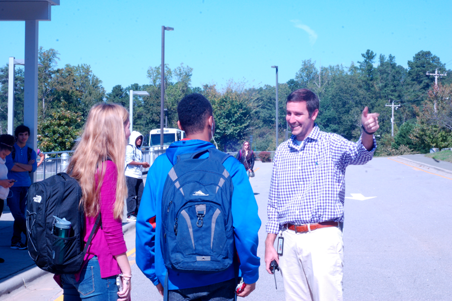 Trey Salacki interacts with students at the bus loop. Salack interned at Heritage High School before joining the Cougars this year.