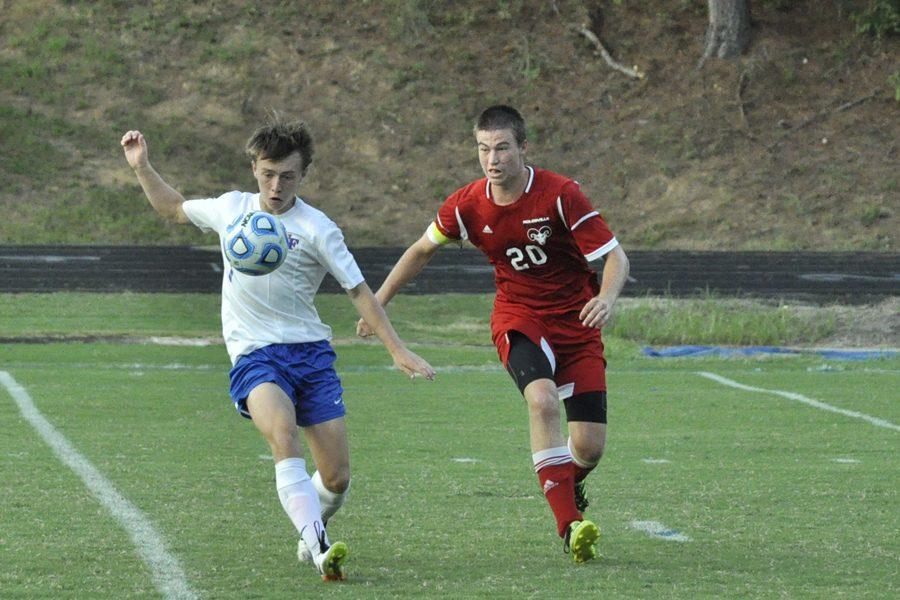 Junior John Autry takes on Rolesville defense at the Devils Cup, which was won 3 to 2. Autry scored the game-winning goal in the final minute of the game.