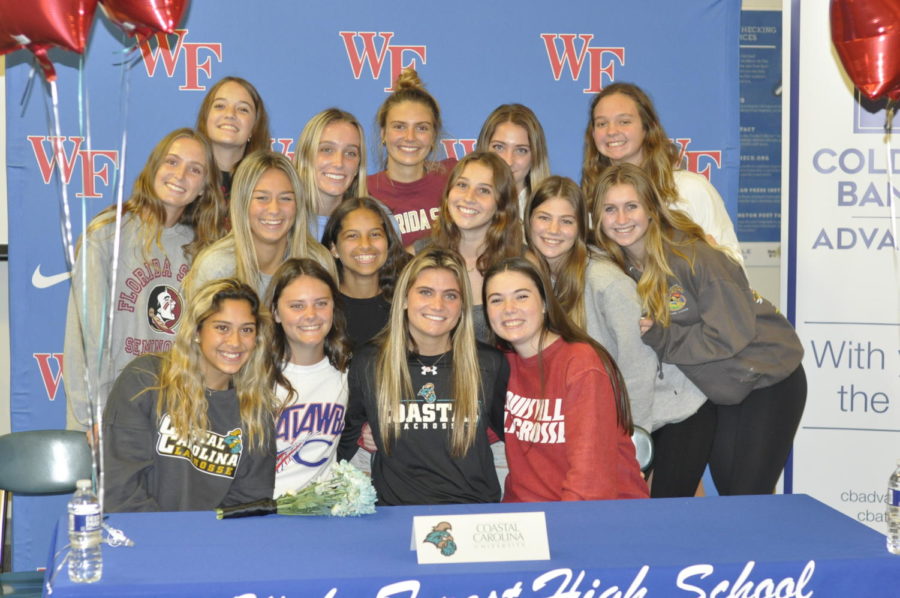 Gabi+Beaudet%2C+center%2C+celebrates+with+her+teammates+and+fellow+signees+Chloe+Ames+%28left%29+and+Hanna+John+%28right%29+on+Nov.+7+signing+day